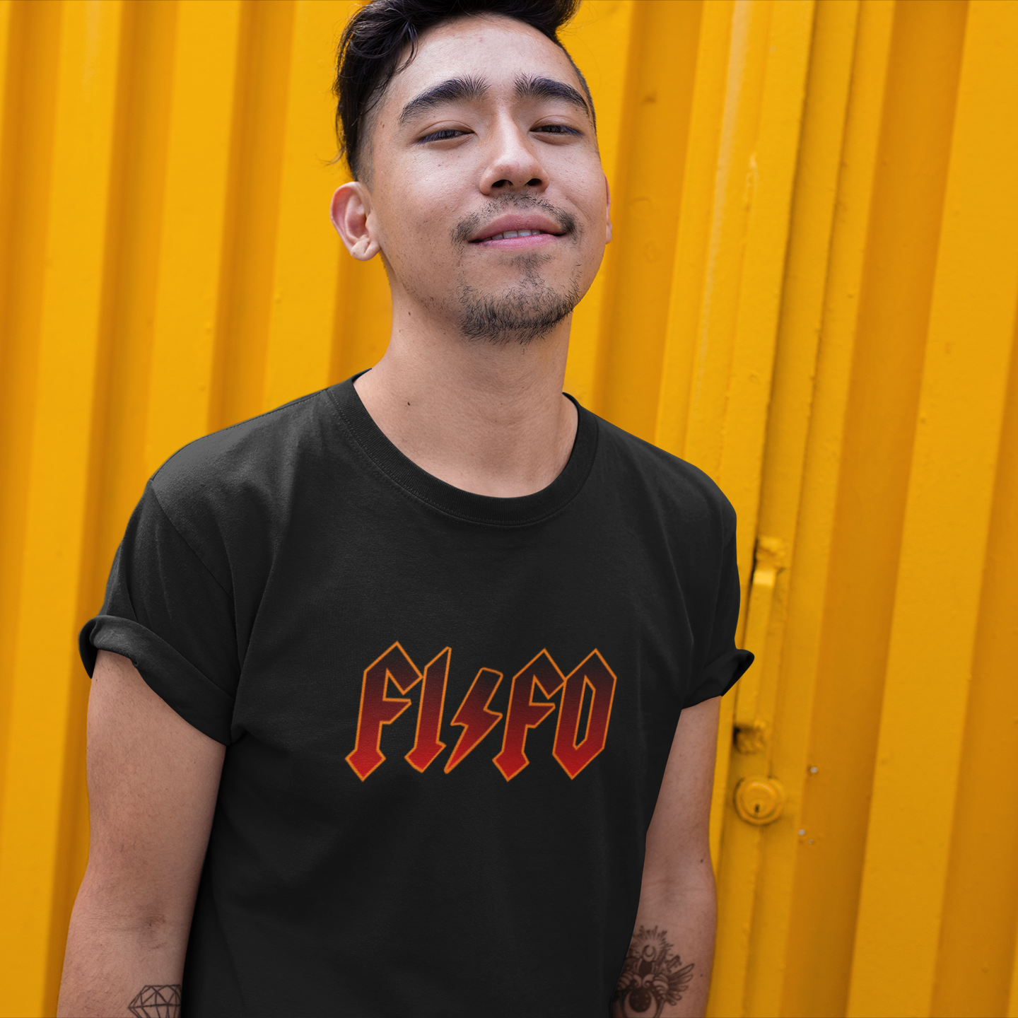 Man wearing a black t-shirt with 'FLSFO' text in red against a yellow background
