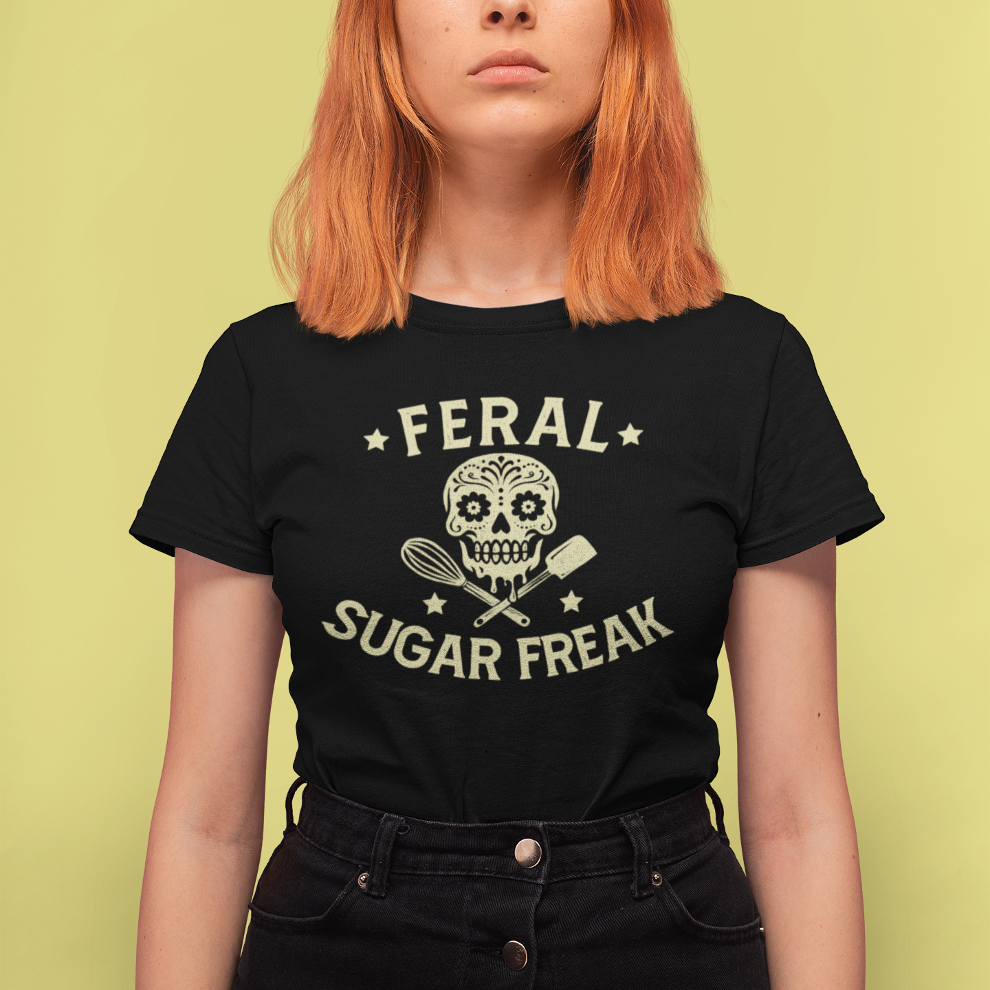 Person wearing a black t-shirt with 'Feral Sugar Freak' design on a yellow background