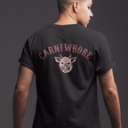 Person wearing a black t-shirt with 'Carniwhore' logo on the back against a dark background