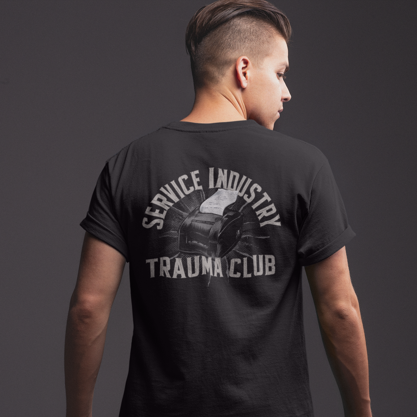 Person wearing a black t-shirt with 'RSDD BOXING' design on the back against a dark background