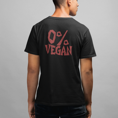 A man viewed from behind wearing a black t-shirt with a red graphic on the back that reads '0% VEGAN', paired with dark jeans, against a plain gray studio background.