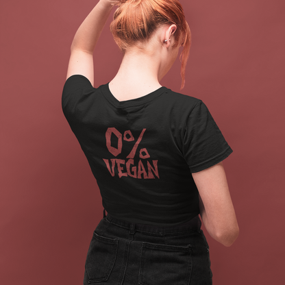A woman with red hair in a bun is shown from behind wearing a black t-shirt with a red graphic that reads '0% VEGAN'. She is posing against a solid dark reddish-brown background.