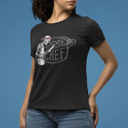 Person wearing a black t-shirt with a graphic design on a blue background