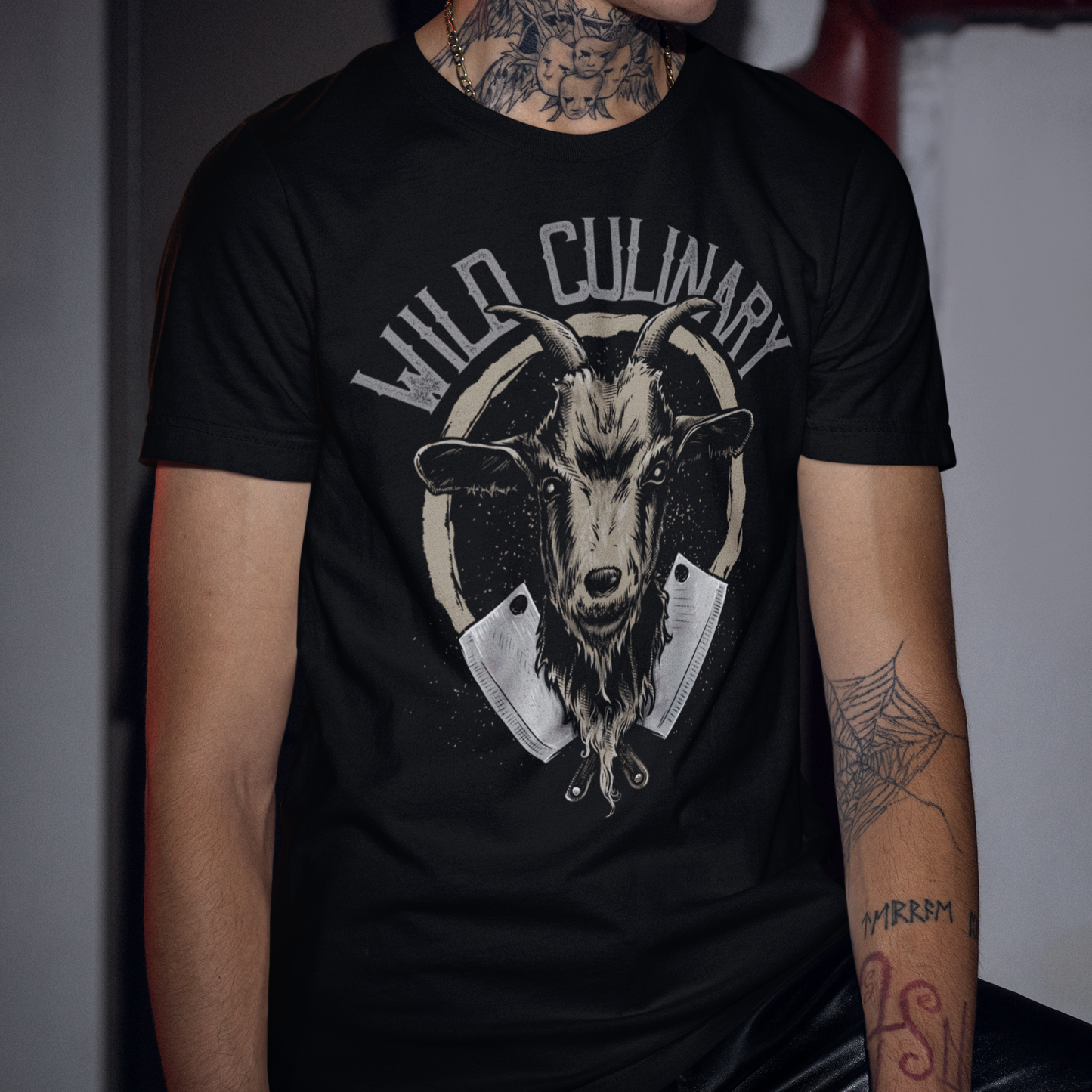 Person wearing a black t-shirt with a goat graphic and 'Wild Culinary' text.