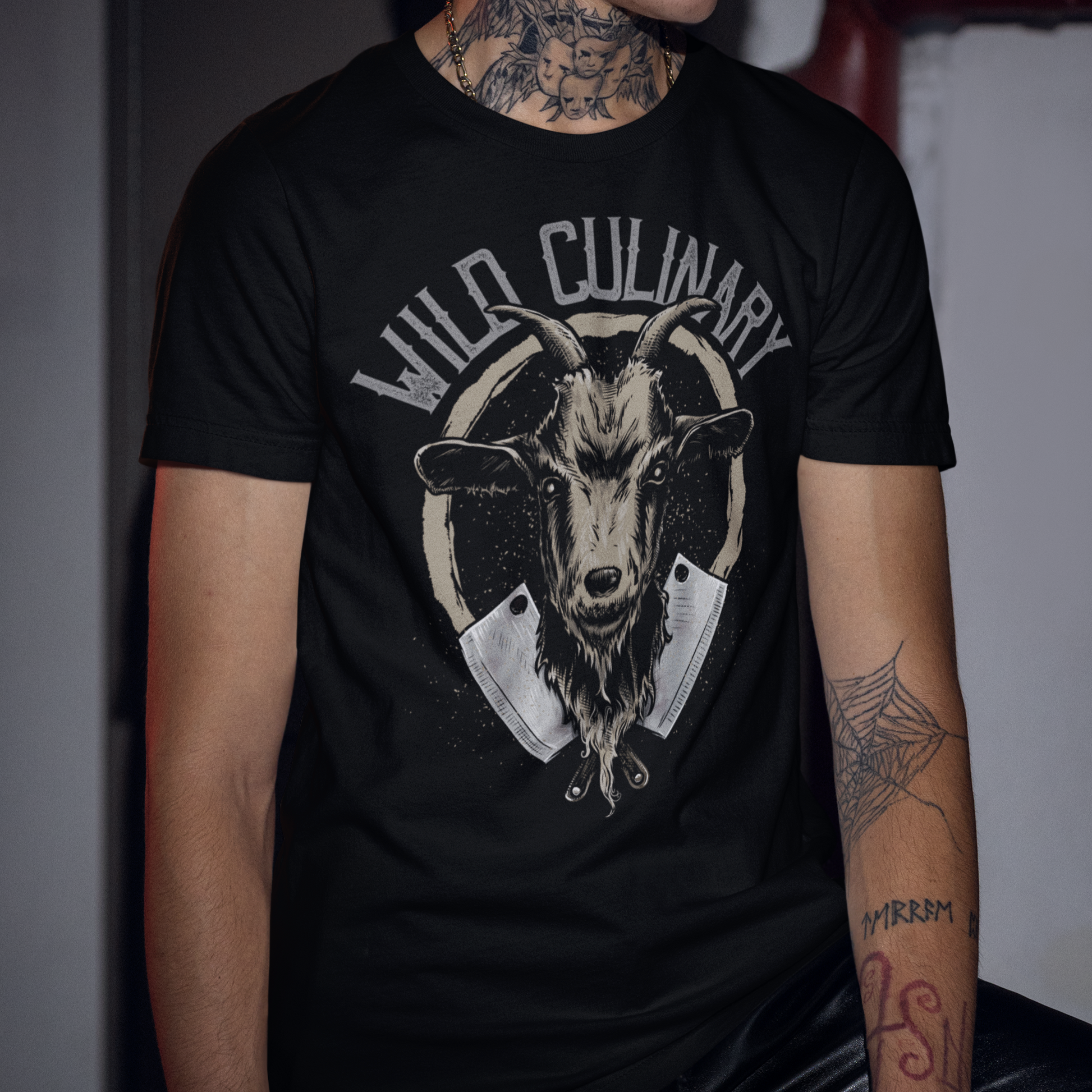 Person wearing a black t-shirt with a goat graphic and 'Wild Culinary' text.