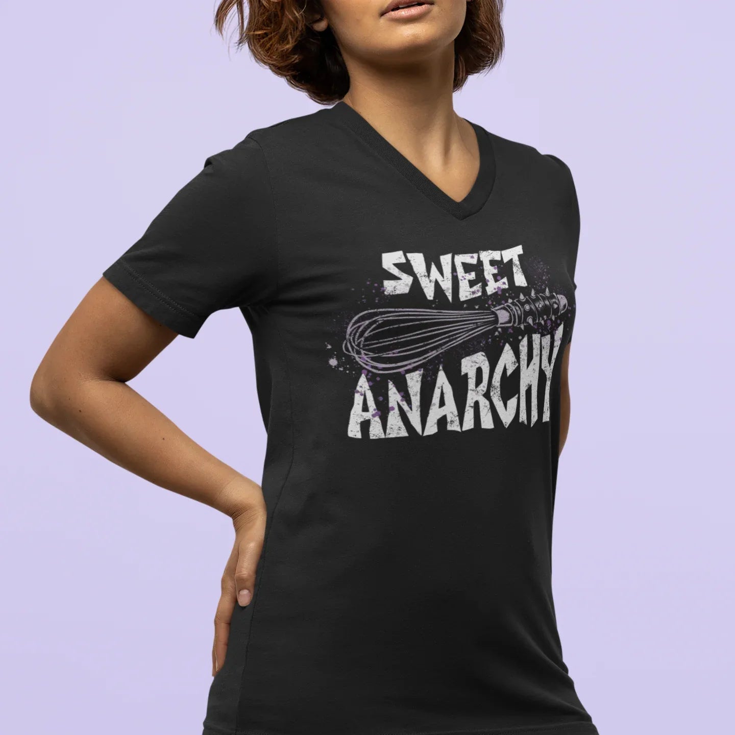 Person wearing a black t-shirt with 'Sweet Anarchy' design on a light purple background