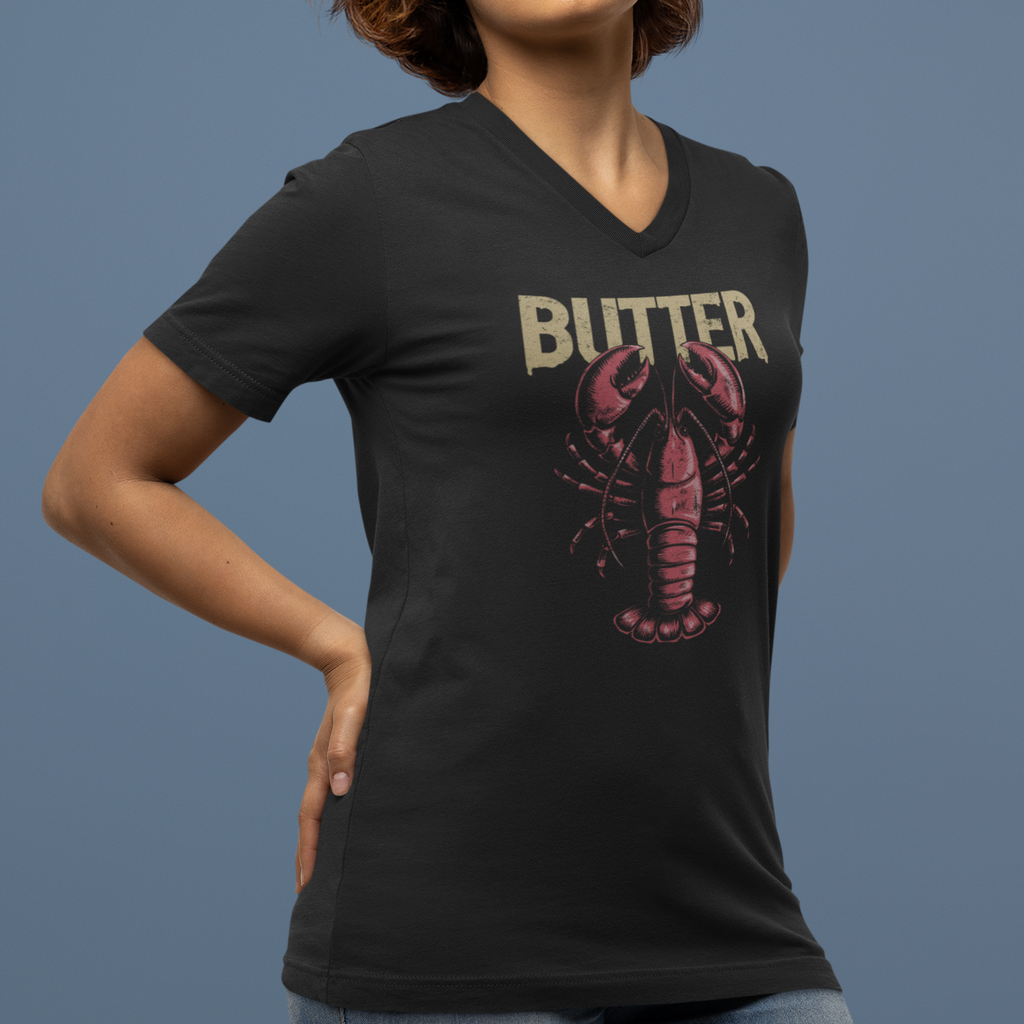 Person wearing a black t-shirt with a graphic design and text on a blue background