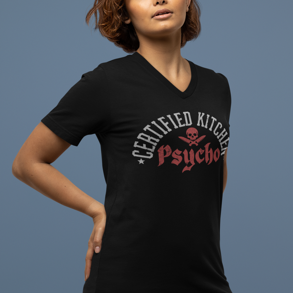 Person wearing a black t-shirt with 'Certified Kitchen Psycho' design on a blue background
