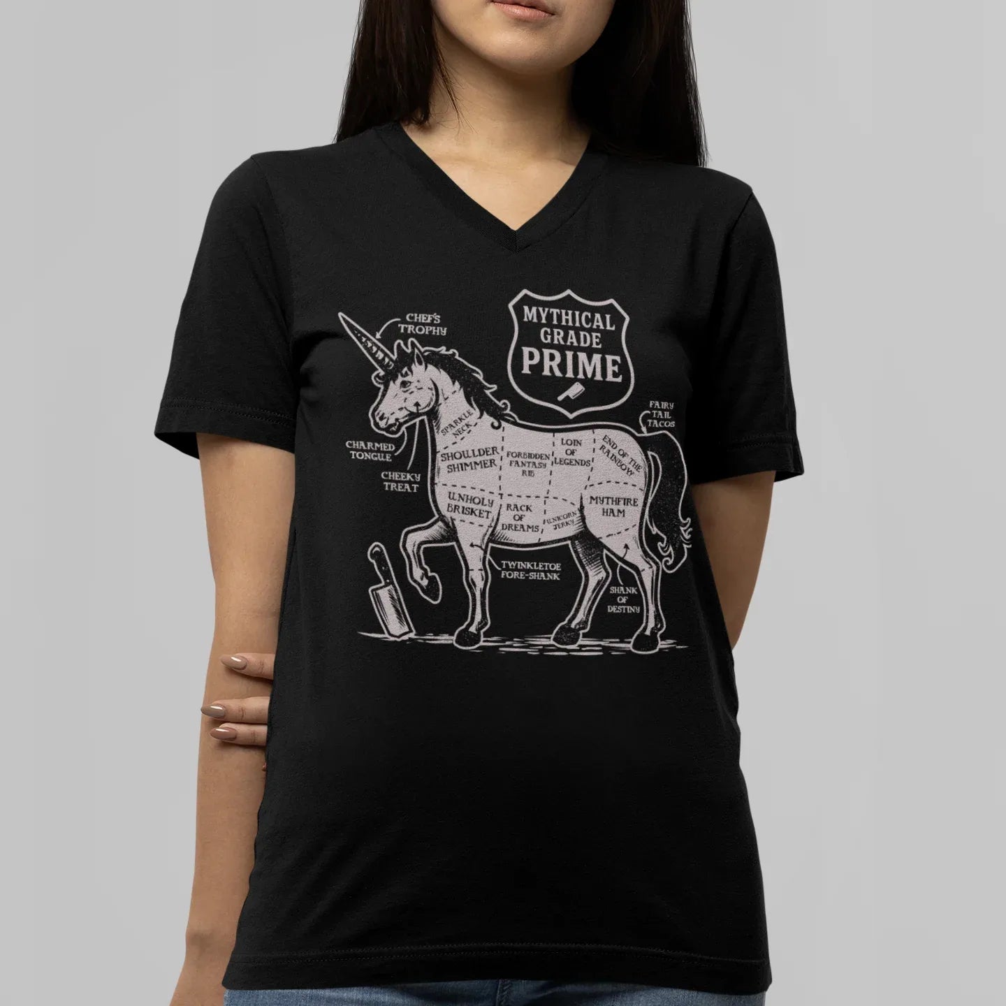 Person wearing a black t-shirt with a unicorn graphic and text on a gray background