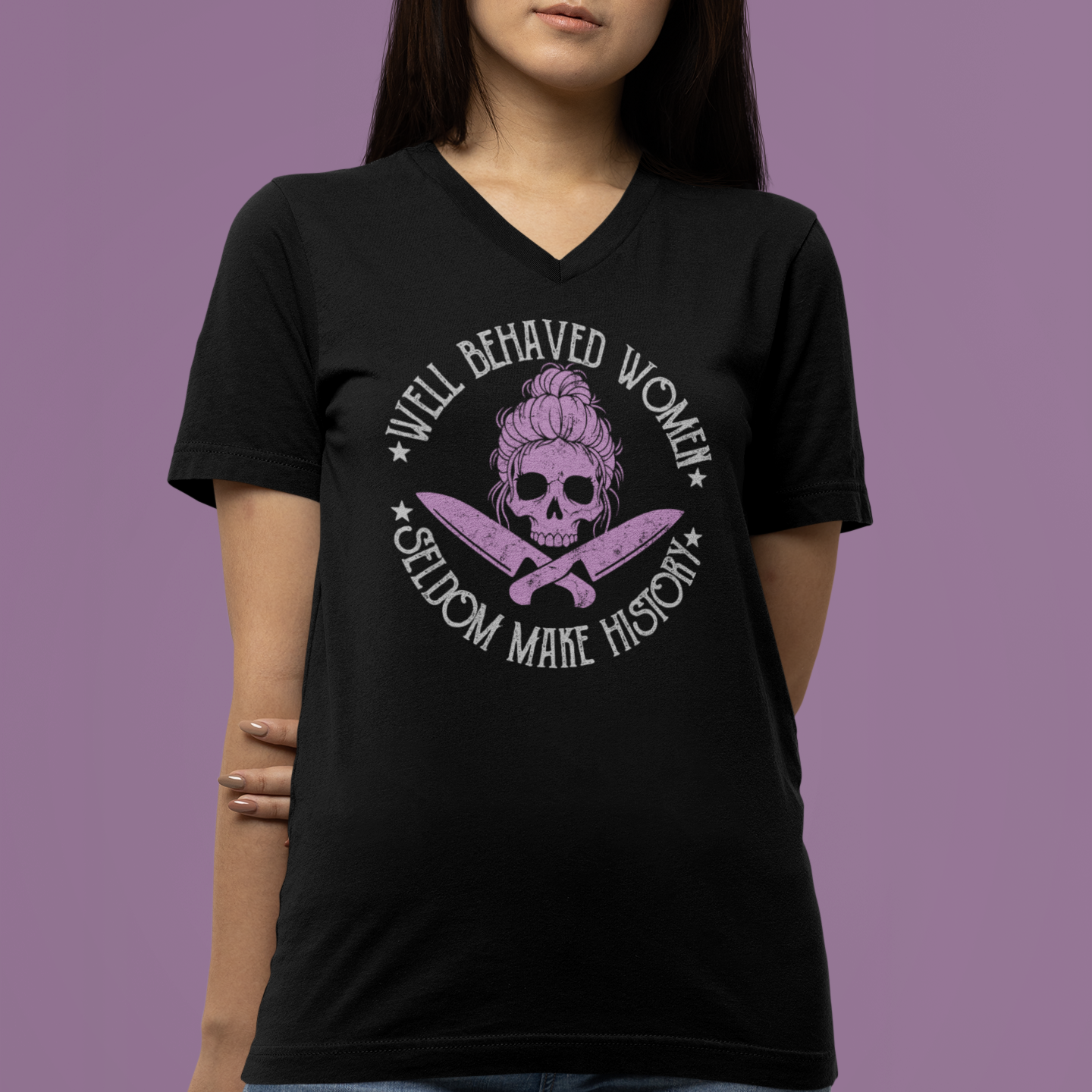 Person wearing a black t-shirt with a graphic design and text against a purple background