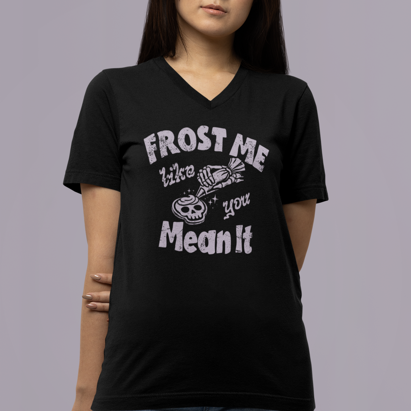 Person wearing a black t-shirt with white text and graphics on a gray background