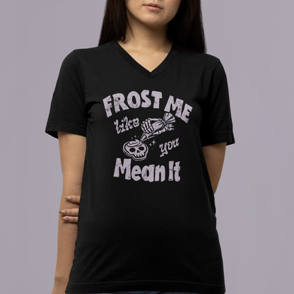 Person wearing a black t-shirt with white text and graphics on a gray background