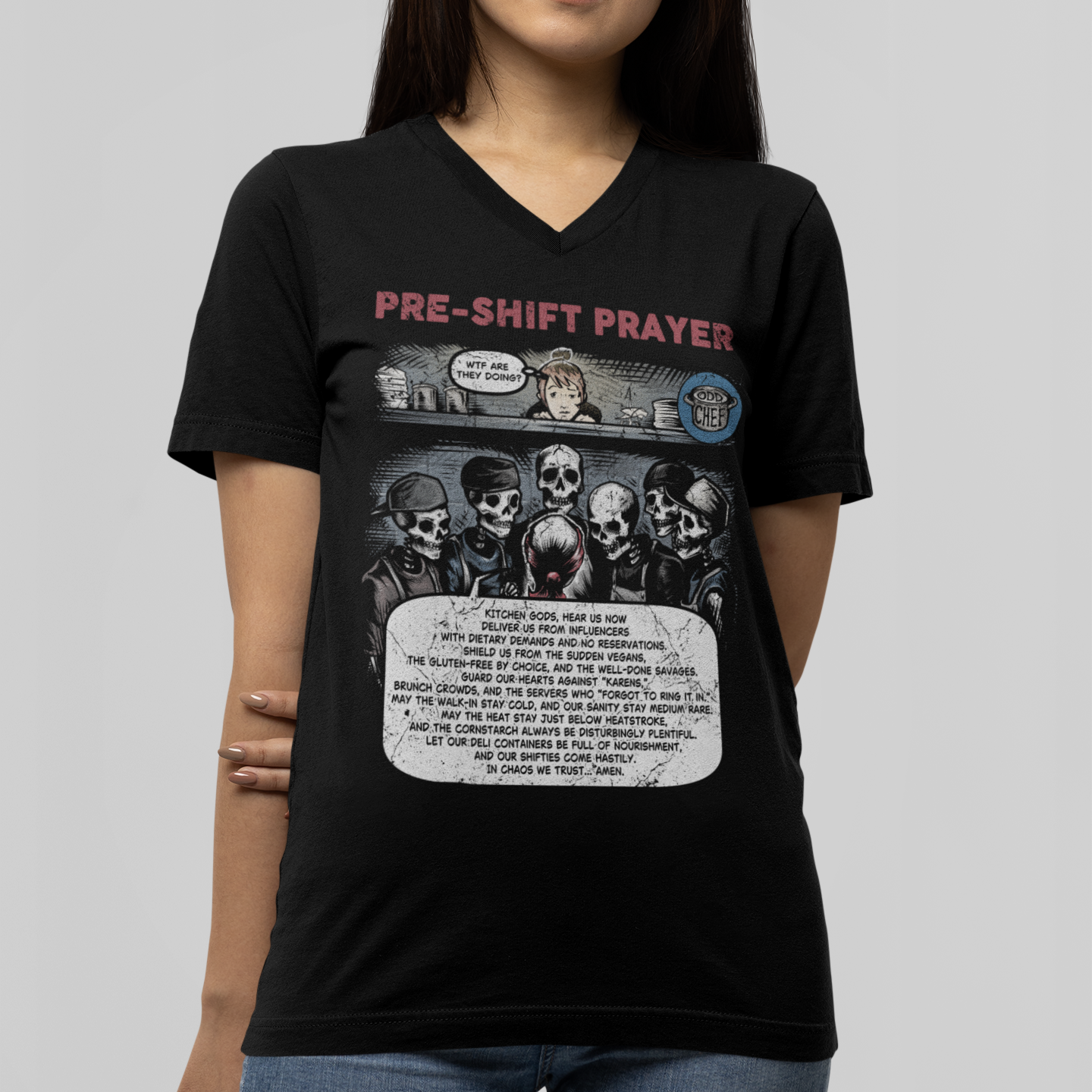 Person wearing a black t-shirt with graphic design and text on a plain background
