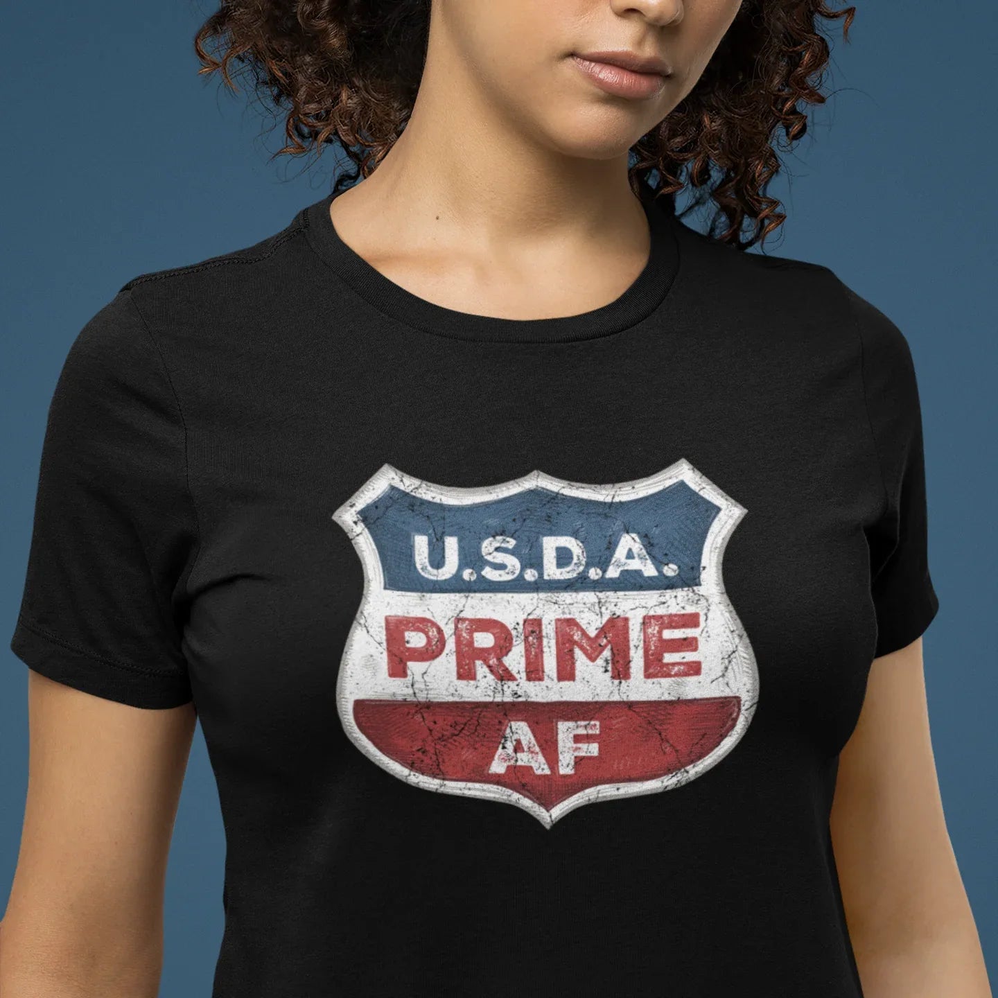 Person wearing a black t-shirt with a USDA Prime AF graphic design.