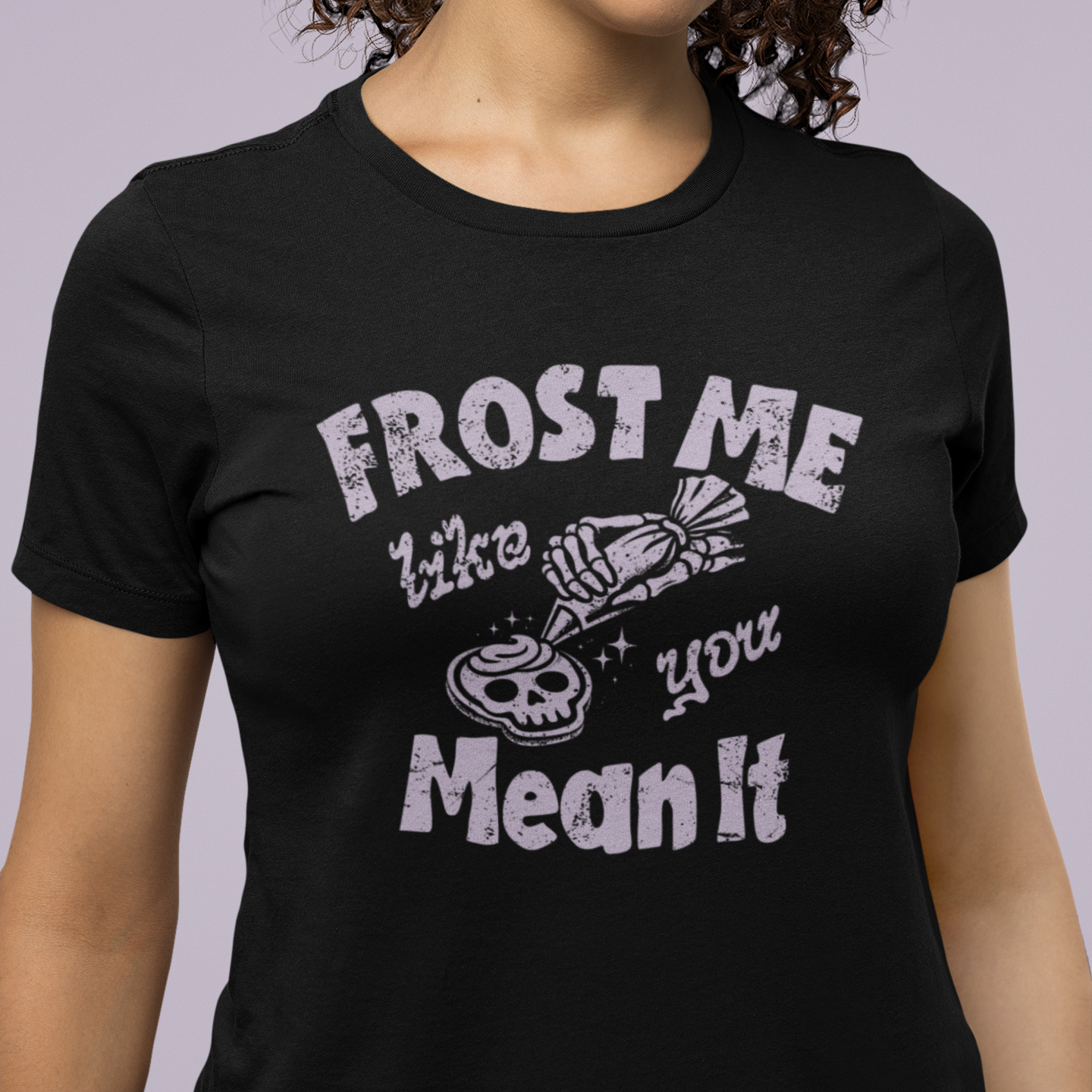 Person wearing a black t-shirt with white text and graphic design on a plain background