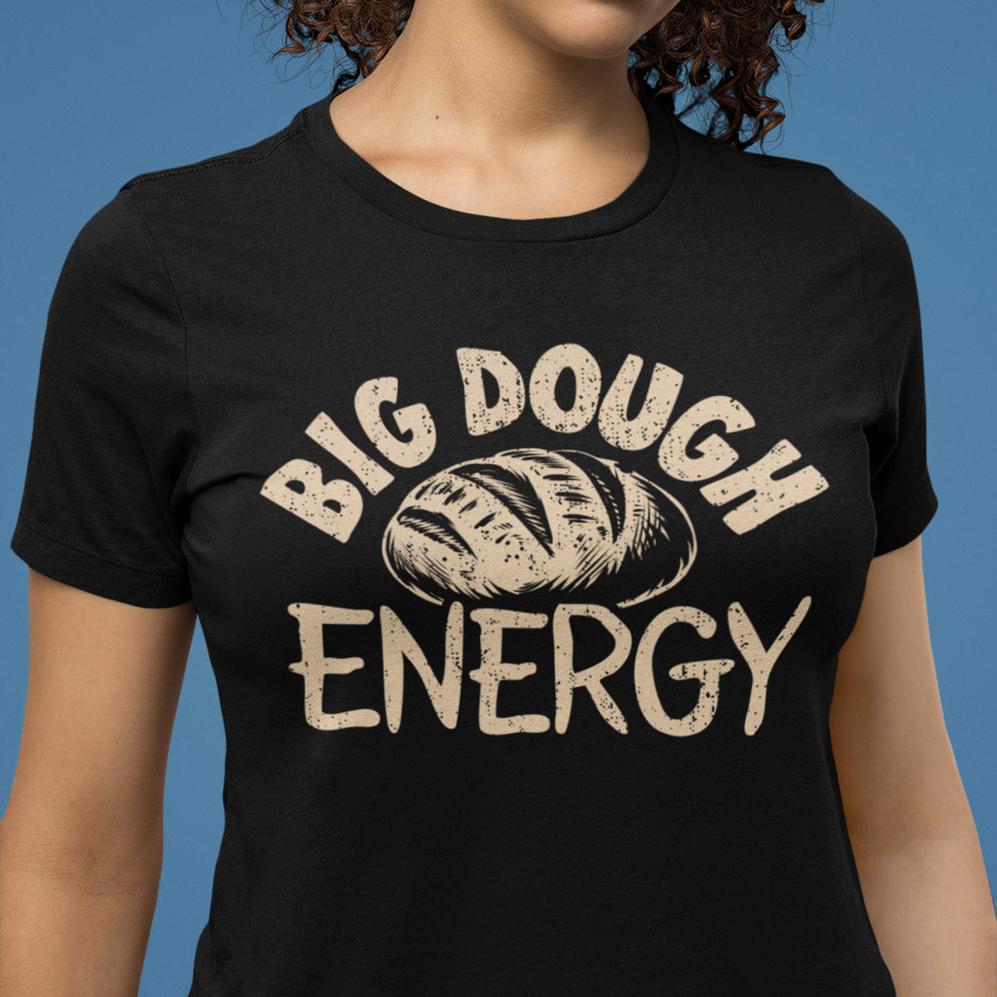 Person wearing a black t-shirt with 'BIG DOUGH ENERGY' text and bread graphic.