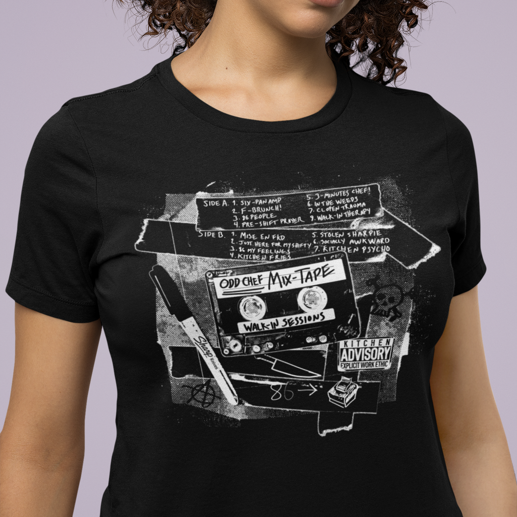 Person wearing a black t-shirt with a graphic design of a cassette tape and text.