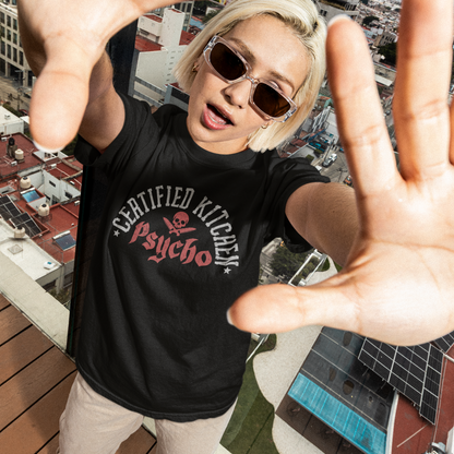 Person wearing a black t-shirt with text and graphics, standing on a rooftop with cityscape in the background.