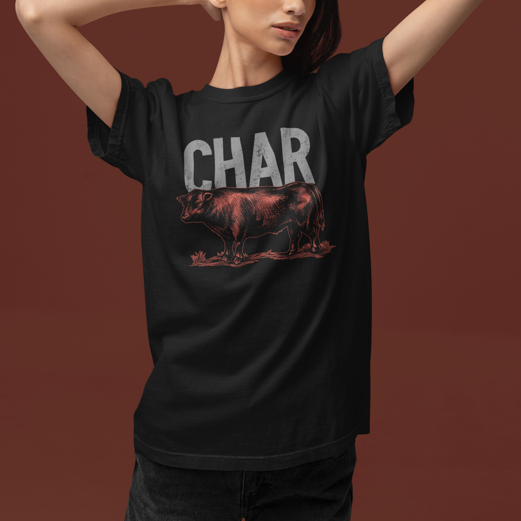 Person wearing a black t-shirt with 'CHAR' printed on it against a brown background