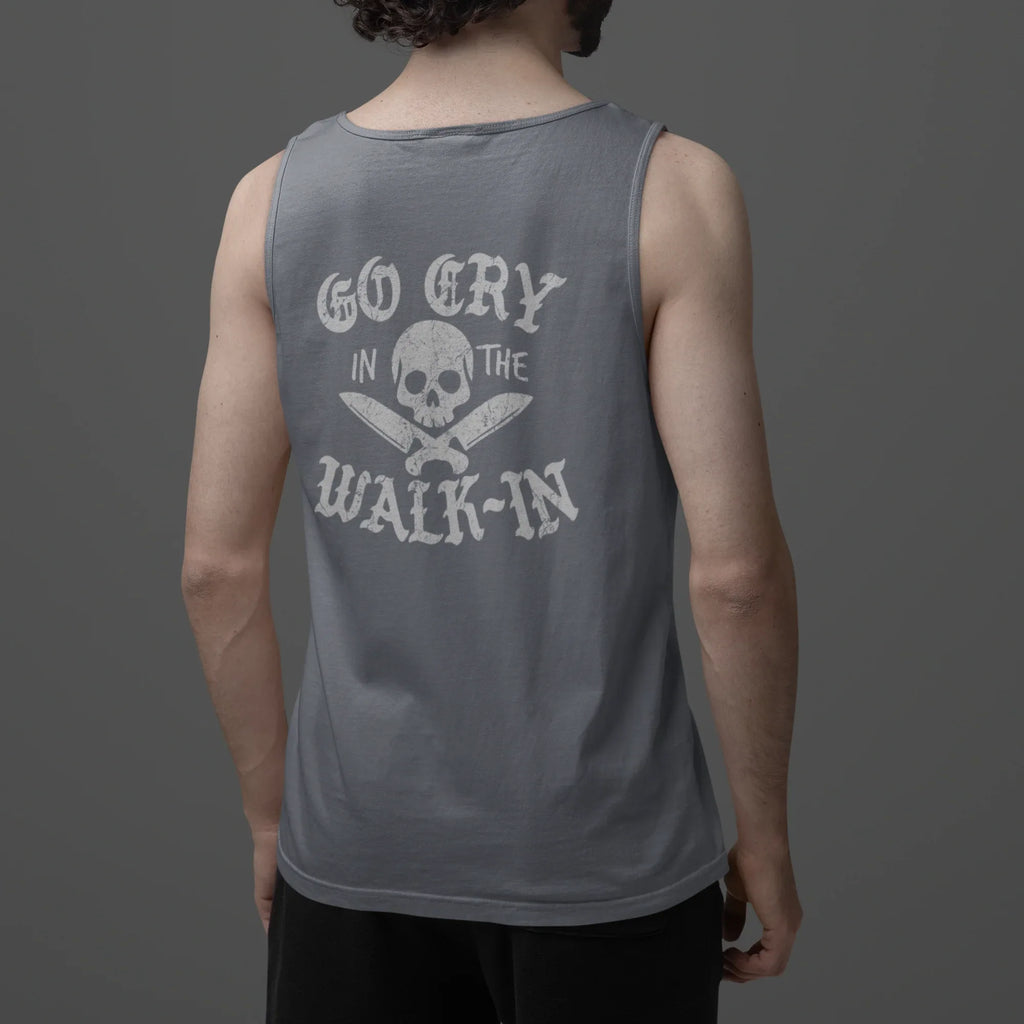 Person wearing a gray tank top with text and skull design on the back against a dark background