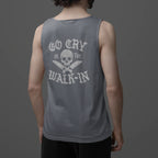 Person wearing a gray tank top with text and skull design on the back against a dark background