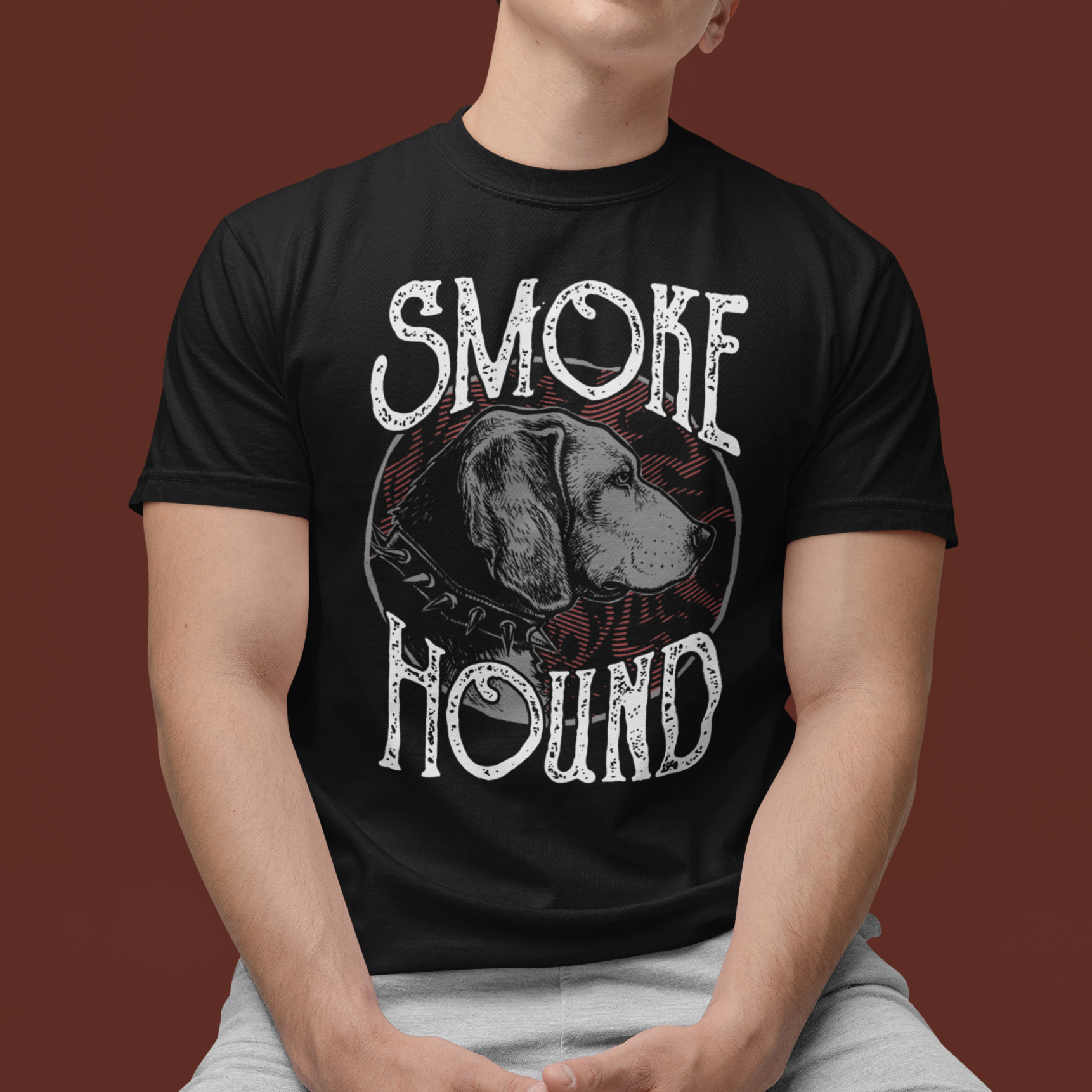 Person wearing a black t-shirt with 'Smoke Hound' design on a brown background