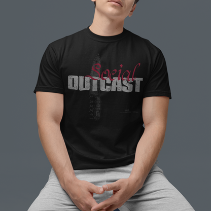 A man wearing a black graphic t-shirt with 'Social OUTCAST' printed on the front, paired with light gray shorts, posed against a solid dark gray background.