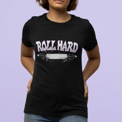 Person wearing a black t-shirt with 'Roll Hard' text and graphic on a light purple background