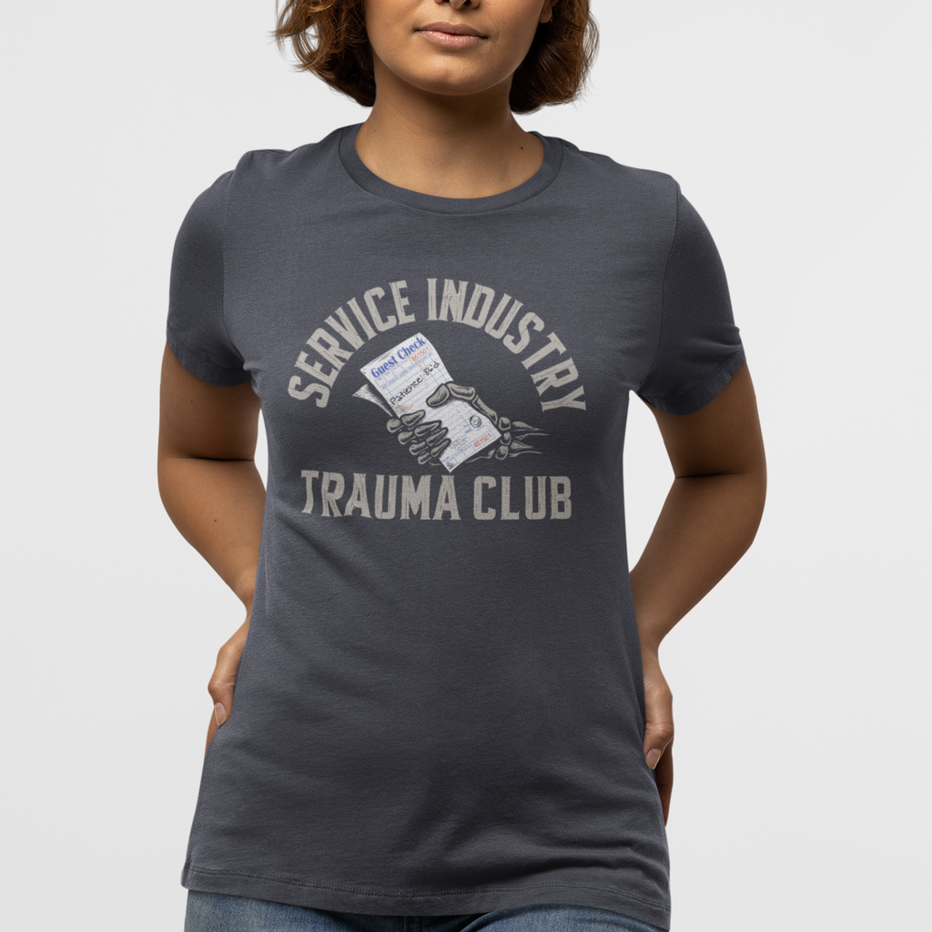 Person wearing a dark gray t-shirt with 'Service Industry Trauma Club' text and graphic on a white background