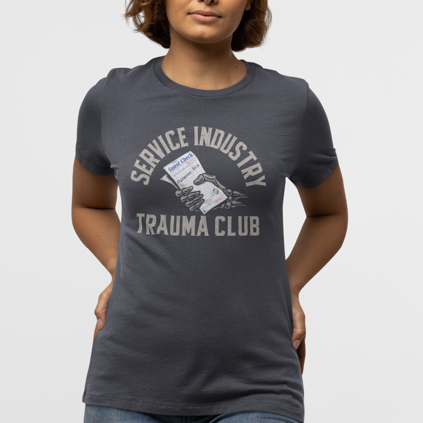 Person wearing a dark gray t-shirt with 'Service Industry Trauma Club' text and graphic on a white background