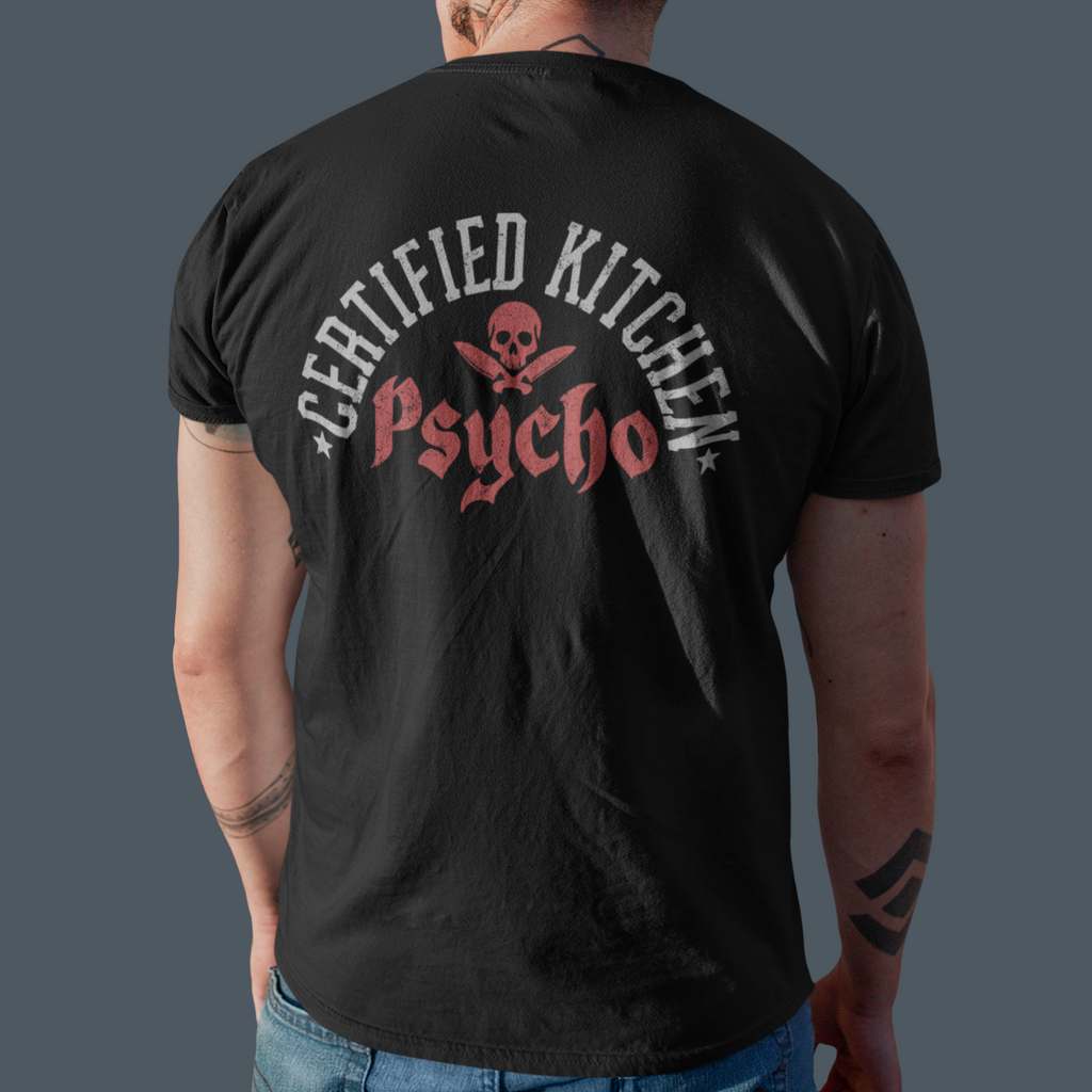Person wearing a black t-shirt with 'Certified Kitchen Psycho' design on the back against a gray background