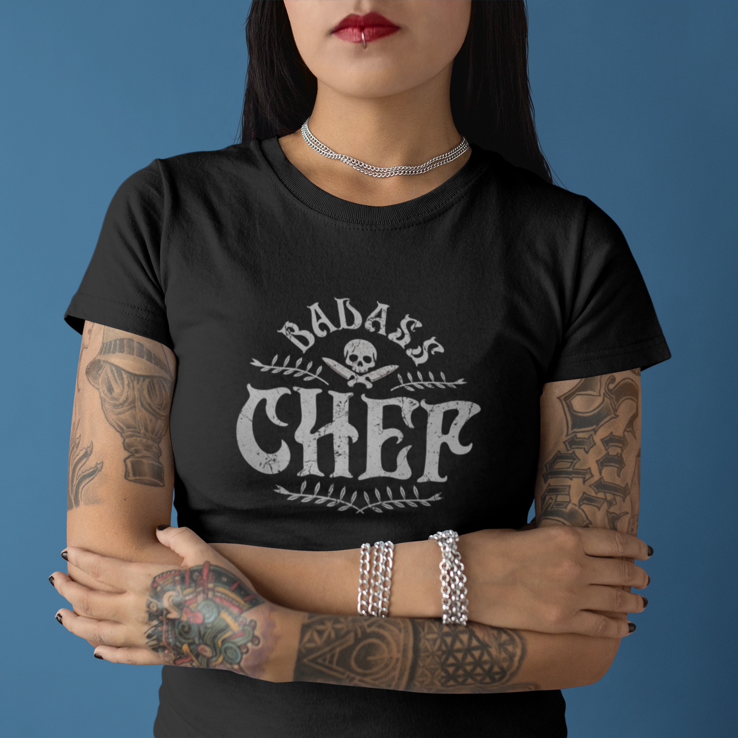 Person wearing a black t-shirt with 'Badass Chef' design against a blue background
