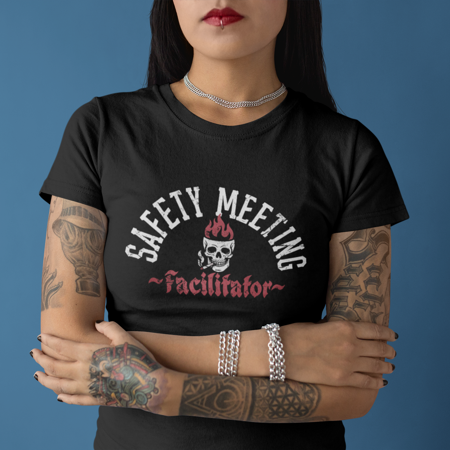 Person wearing a black t-shirt with 'Safety Meeting Facilitator' design on a blue background