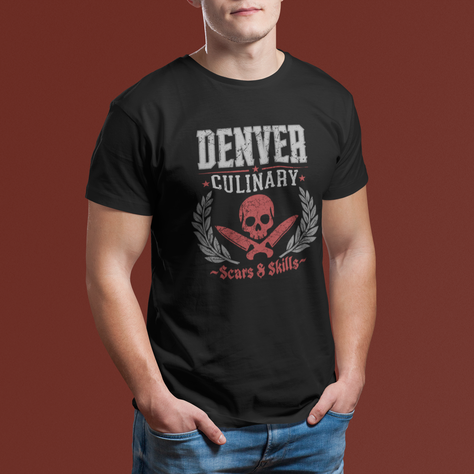 Person wearing a black t-shirt with 'Denver Culinary' design on a brown background
