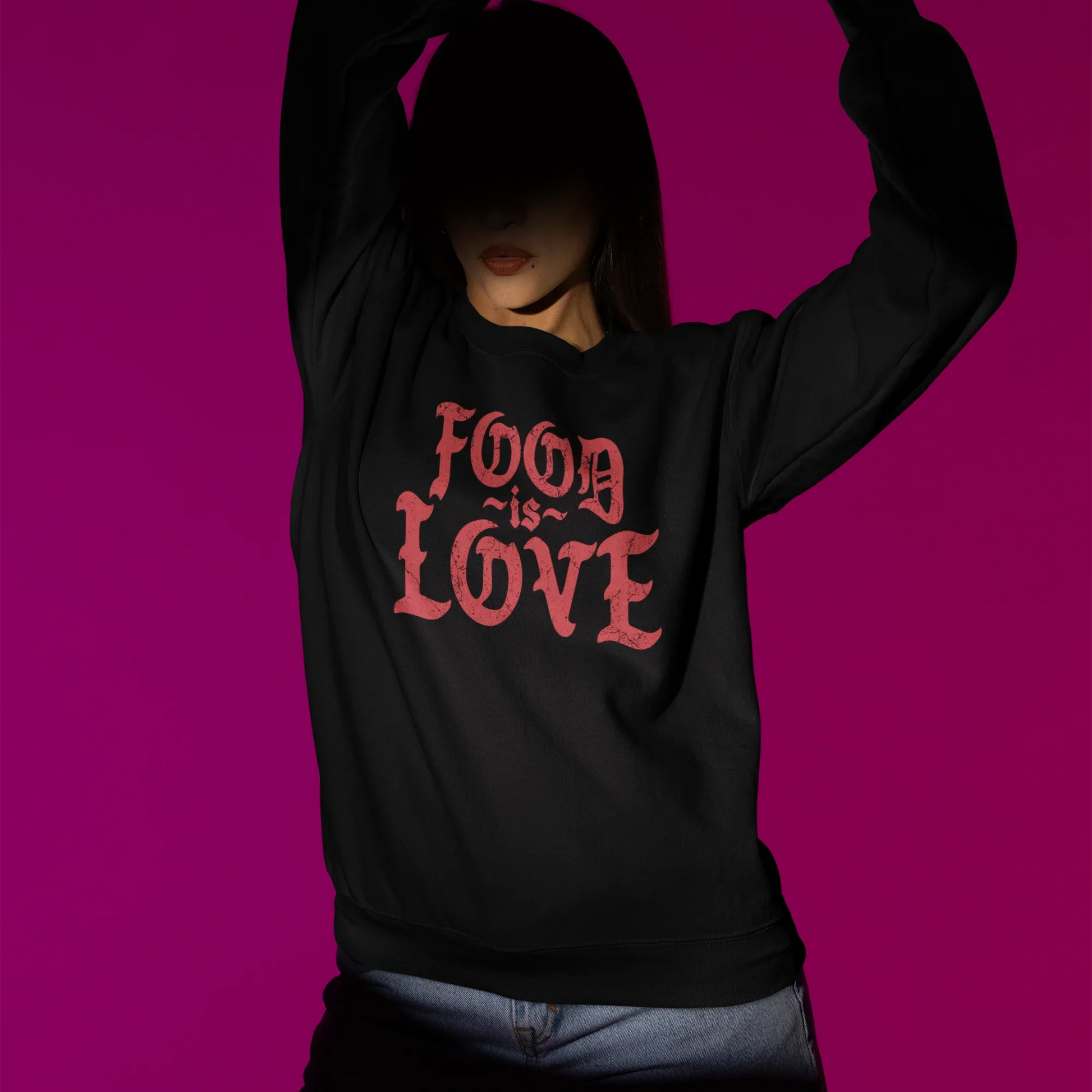 Person wearing a black hoodie with 'FOOD IS LOVE' text on a purple background