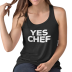 Person wearing a black tank top with 'YES CHEF' text on a white background