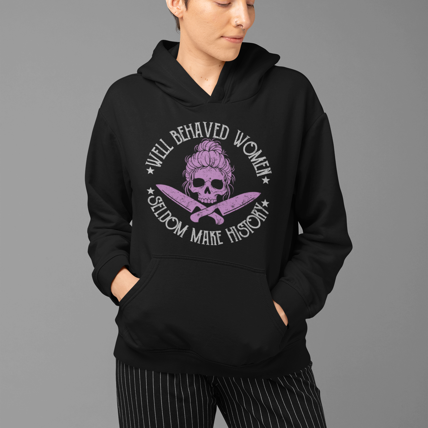 Person wearing a black hoodie with a graphic design on a gray background