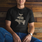 Man wearing a black t-shirt with a graphic design sitting against a wooden wall.