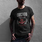 Man wearing a black t-shirt with 'Chicago Culinary' design against a gray wall