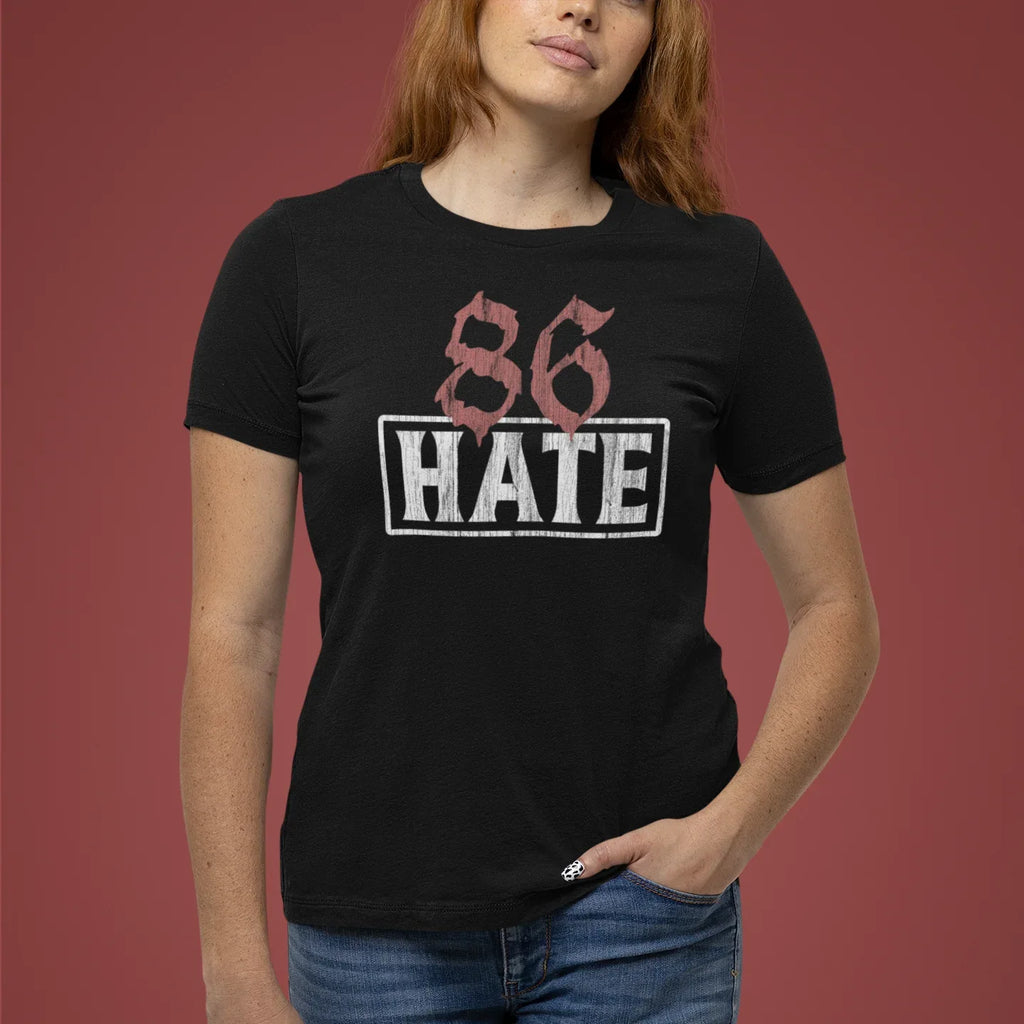 Person wearing a black t-shirt with '86 HATE' design on a red background