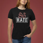 Person wearing a black t-shirt with '86 HATE' design on a red background