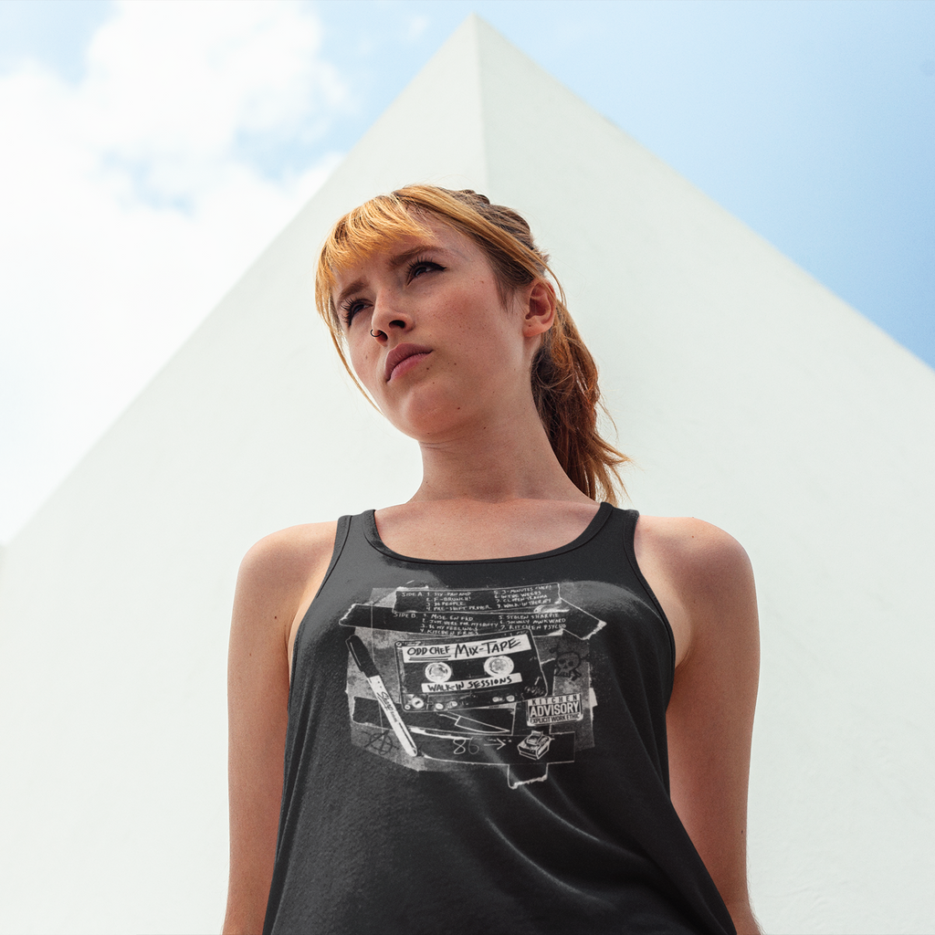 Woman wearing a black tank top with graphic design outdoors