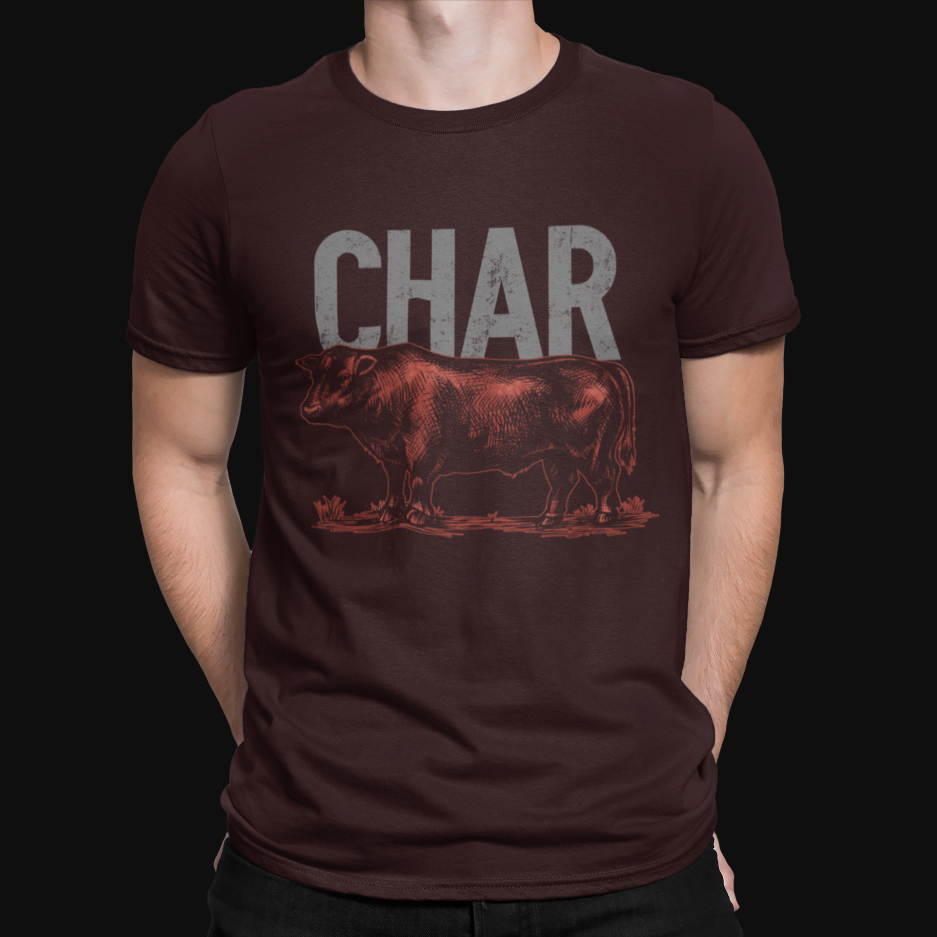 Person wearing a dark brown t-shirt with a graphic of a cow and the word 'CHAR'.
