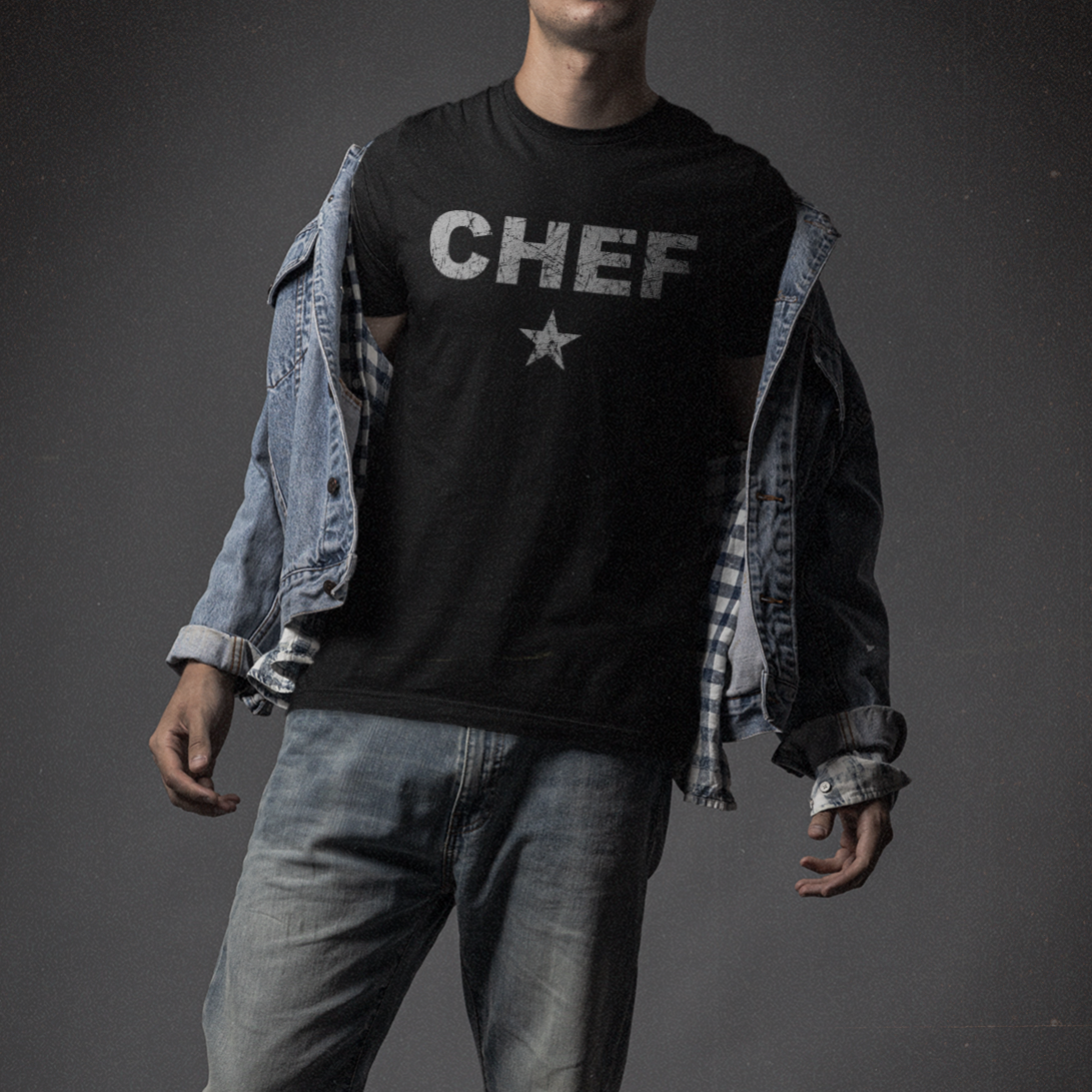 Person wearing a black 'CHEF' t-shirt with a star on a dark background