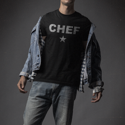 Person wearing a black 'CHEF' t-shirt with a star on a dark background