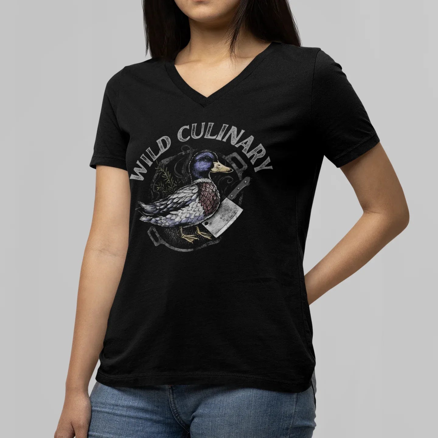 Person wearing a black t-shirt with a duck graphic and 'Wild Culinary' text on a gray background