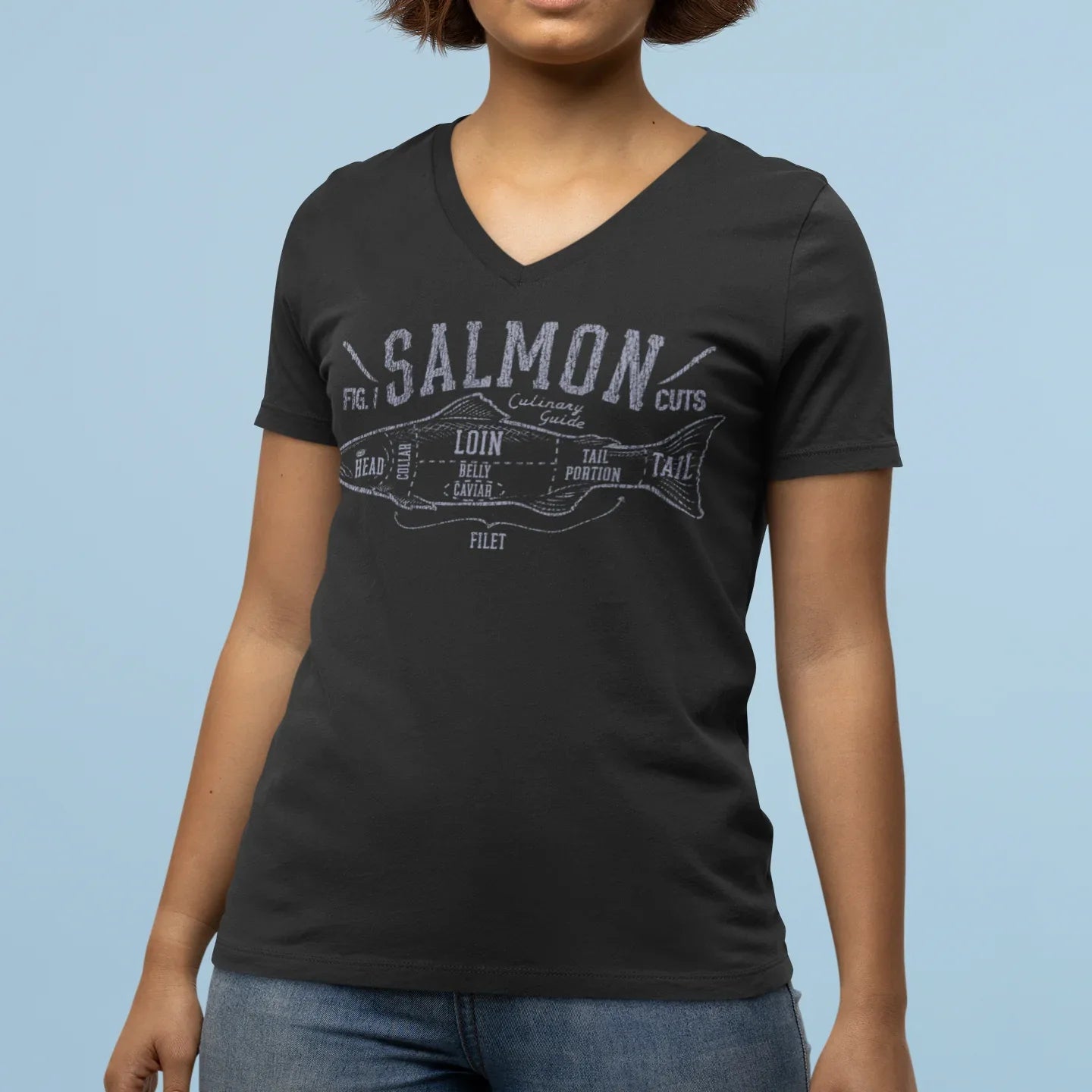 Person wearing a black t-shirt with 'Salmon Cut' graphic design on a light blue background
