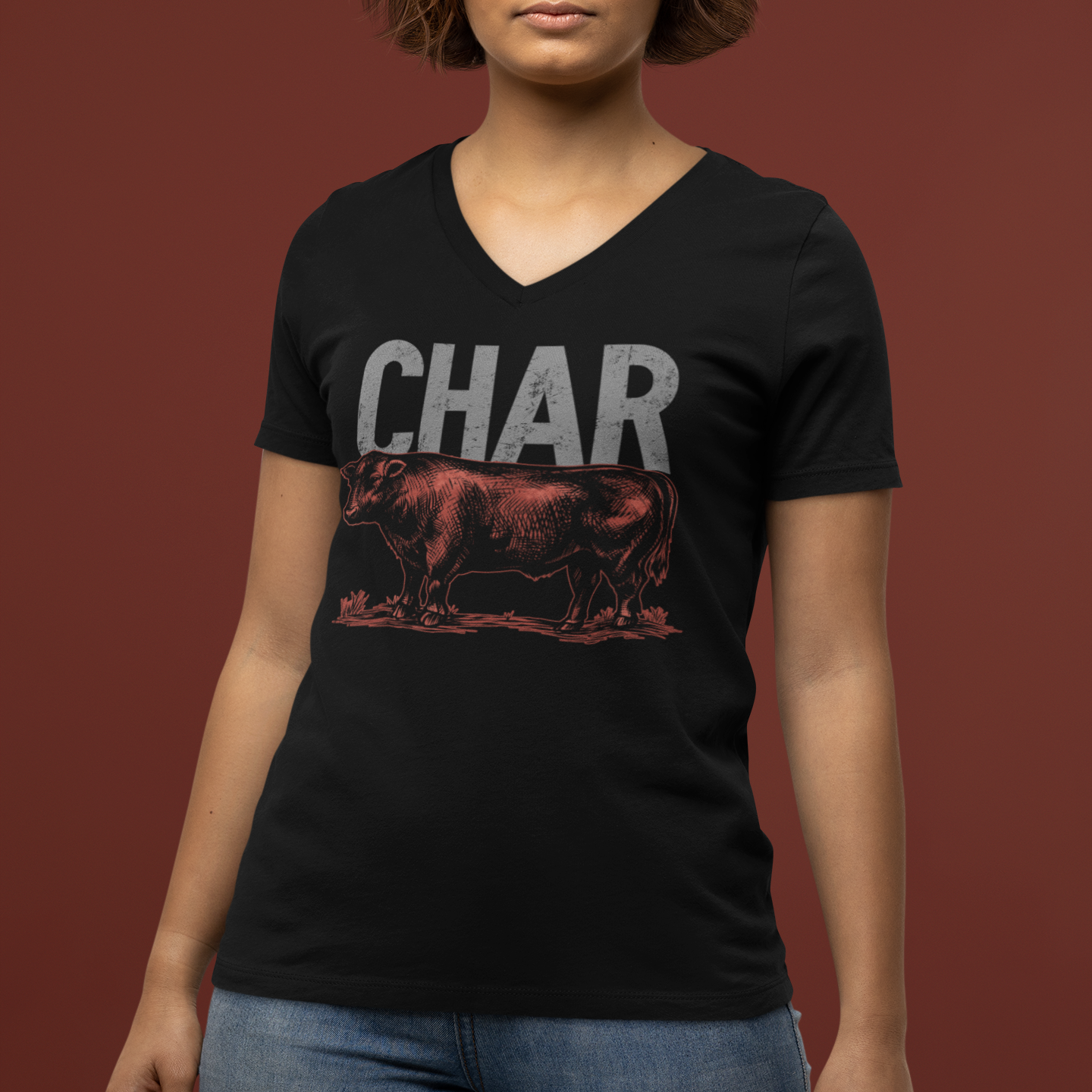 Person wearing a black t-shirt with 'CHAR' and a graphic of a steak on a brown background