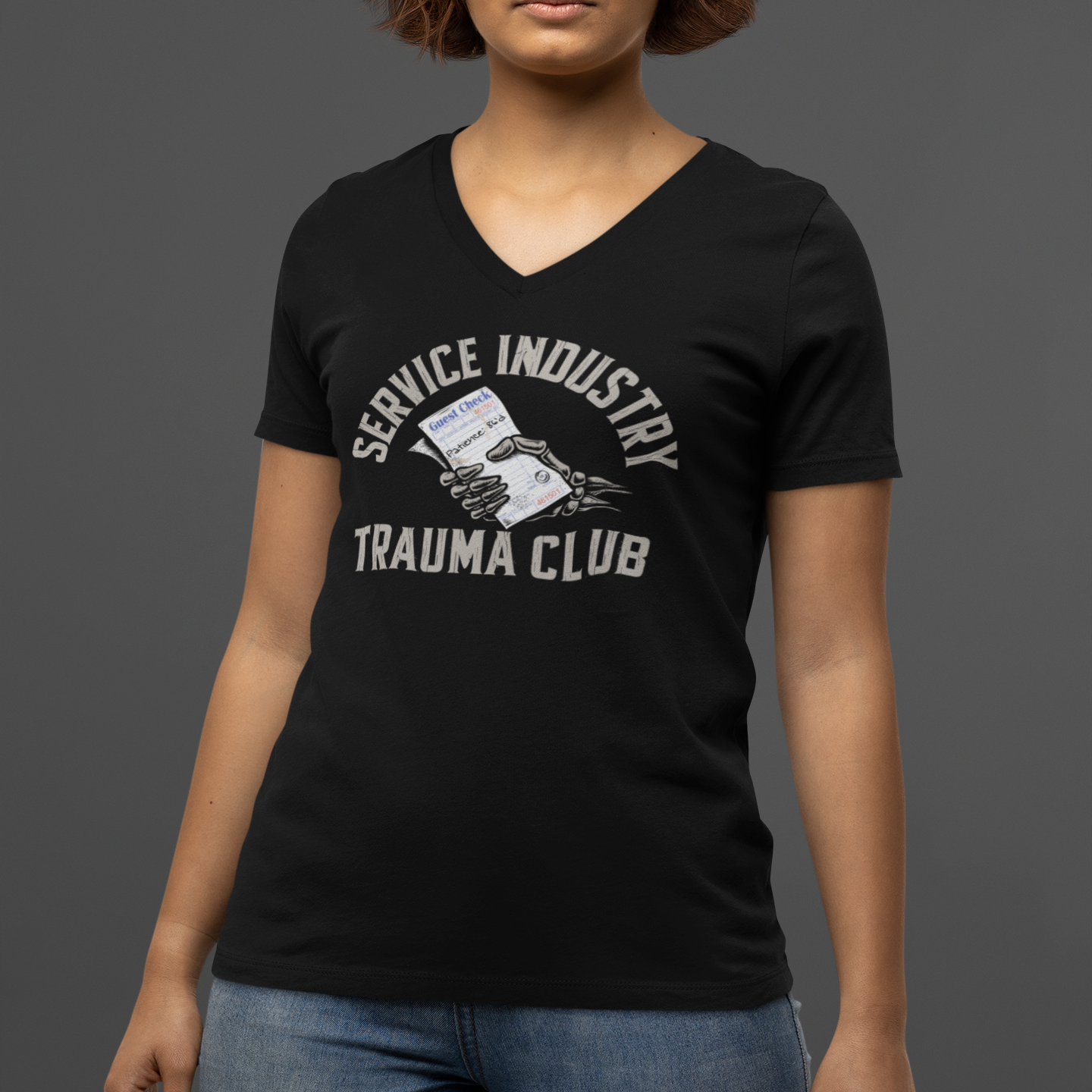 Person wearing a black t-shirt with graphic design and text on a gray background