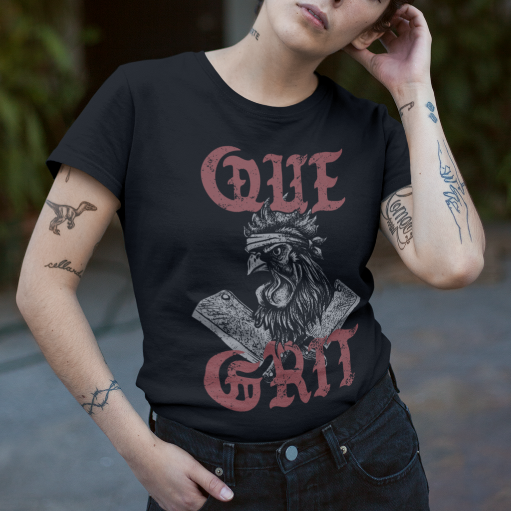 Person wearing a black t-shirt with red text and graphics, standing outdoors.